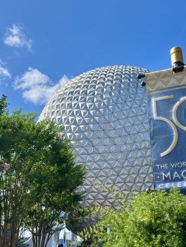 Disney World Tests Out Single Rider Option at EPCOT’s Soarin’ Attraction 25 EPCOT ball with 50th signage and trees