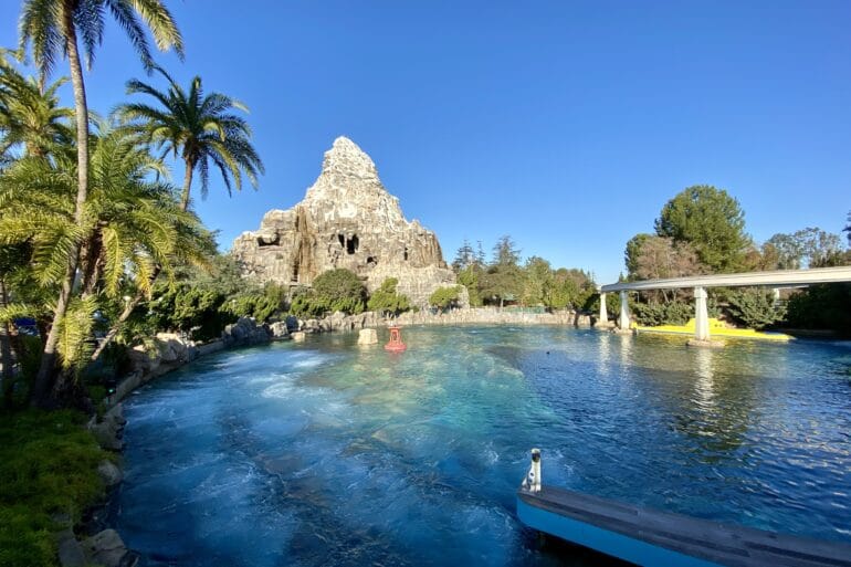 Finding Nemo Submarine Voyage Will Reopen July 25th at Disneyland 117 Lagoon with yellow submarine and mountain