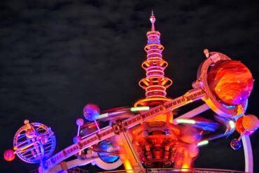 Where to Play, Eat & Shop in Tomorrowland – Walt Disney World Guide 49 Astro Orbiter in Tomorrowland at Magic Kingdom Park at night