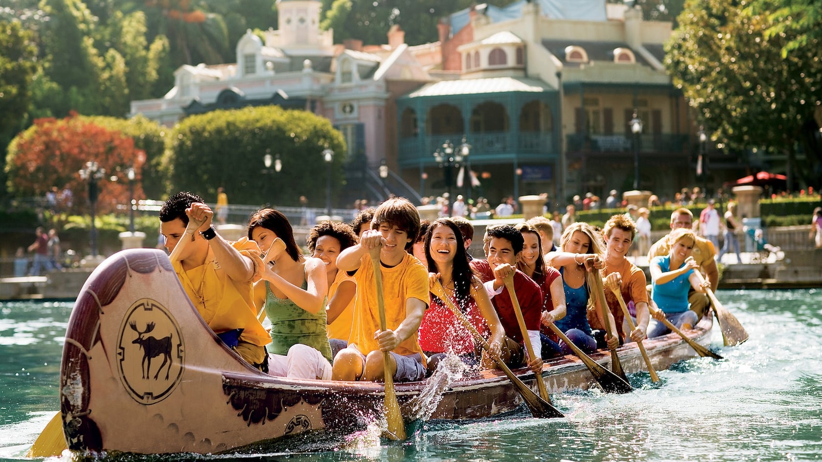 People canoeing with building in background